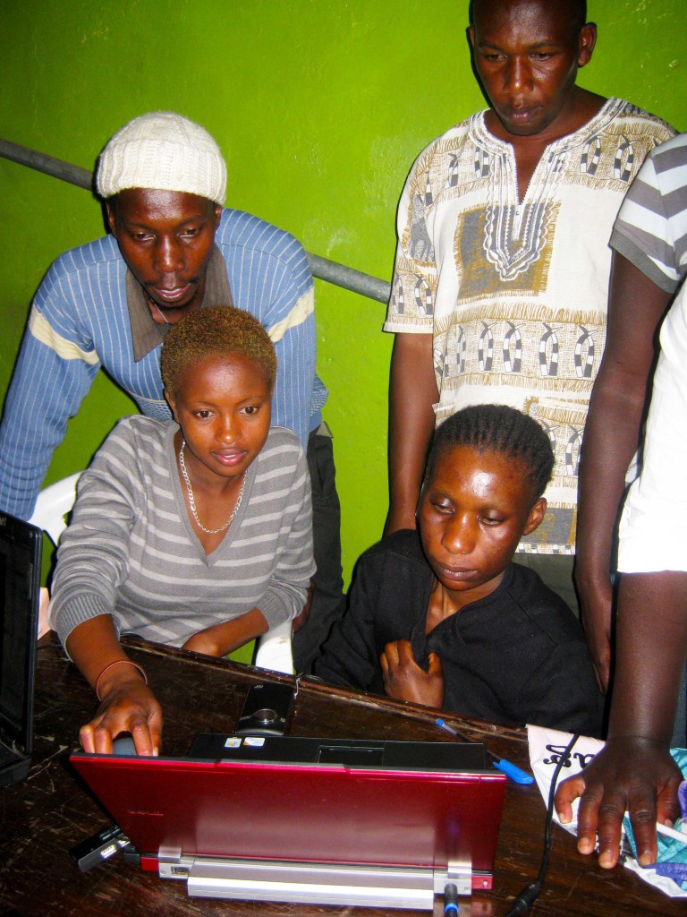 Joe from Kibera News Network (white cap) in action