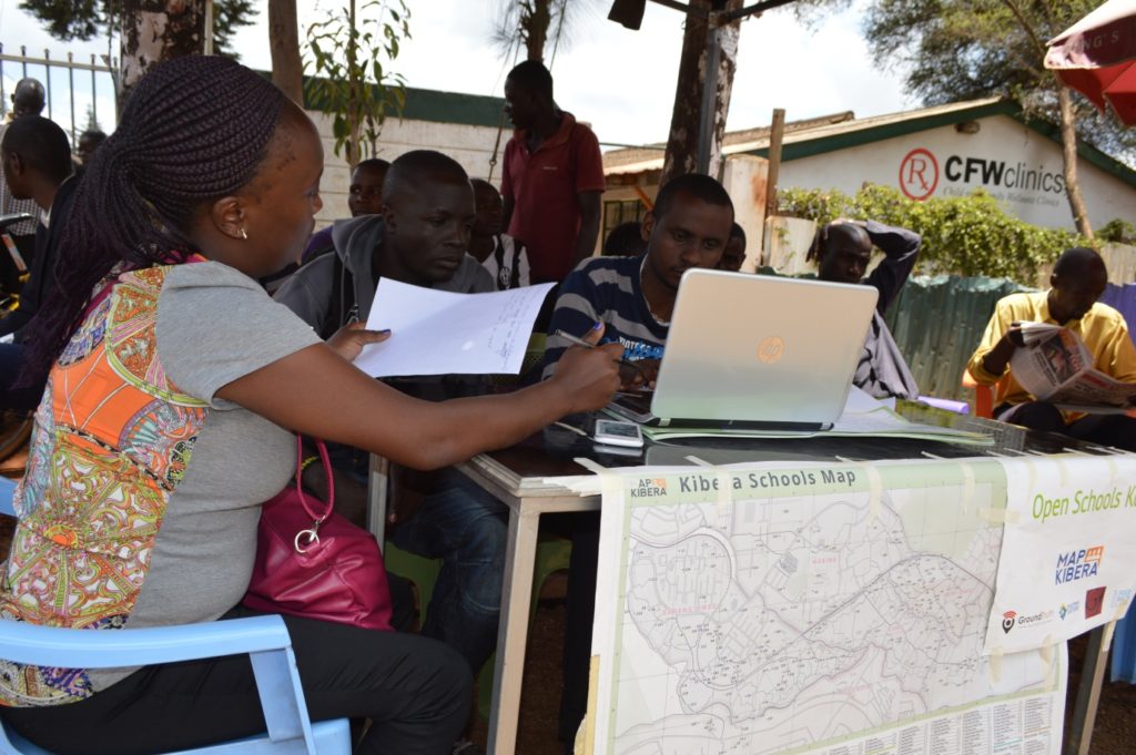 Lucy, Steve and Zack of Map Kibera getting ready at the booth