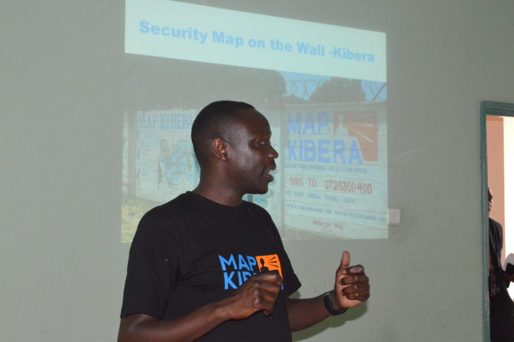 Joshua Ogure introducing the team to the work of of Map Kibera Trust