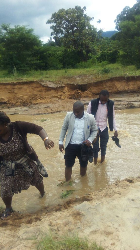 One of the team crossing a river in order to access points that are on the other side