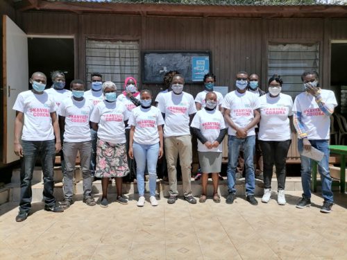 Map Kibera staff together with community volunteers who participated in the project clad in the T-shirts that were distributed to create awareness.