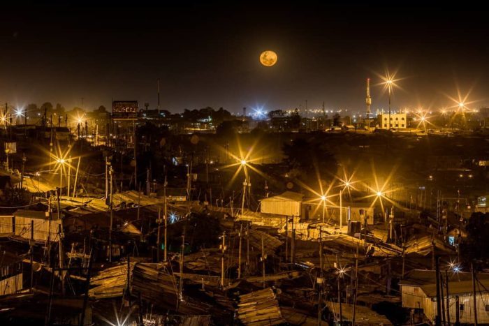 The moon rises above the sky in Kibera. Photo by © Bryan Jaybee @storitellah #KiberaStories